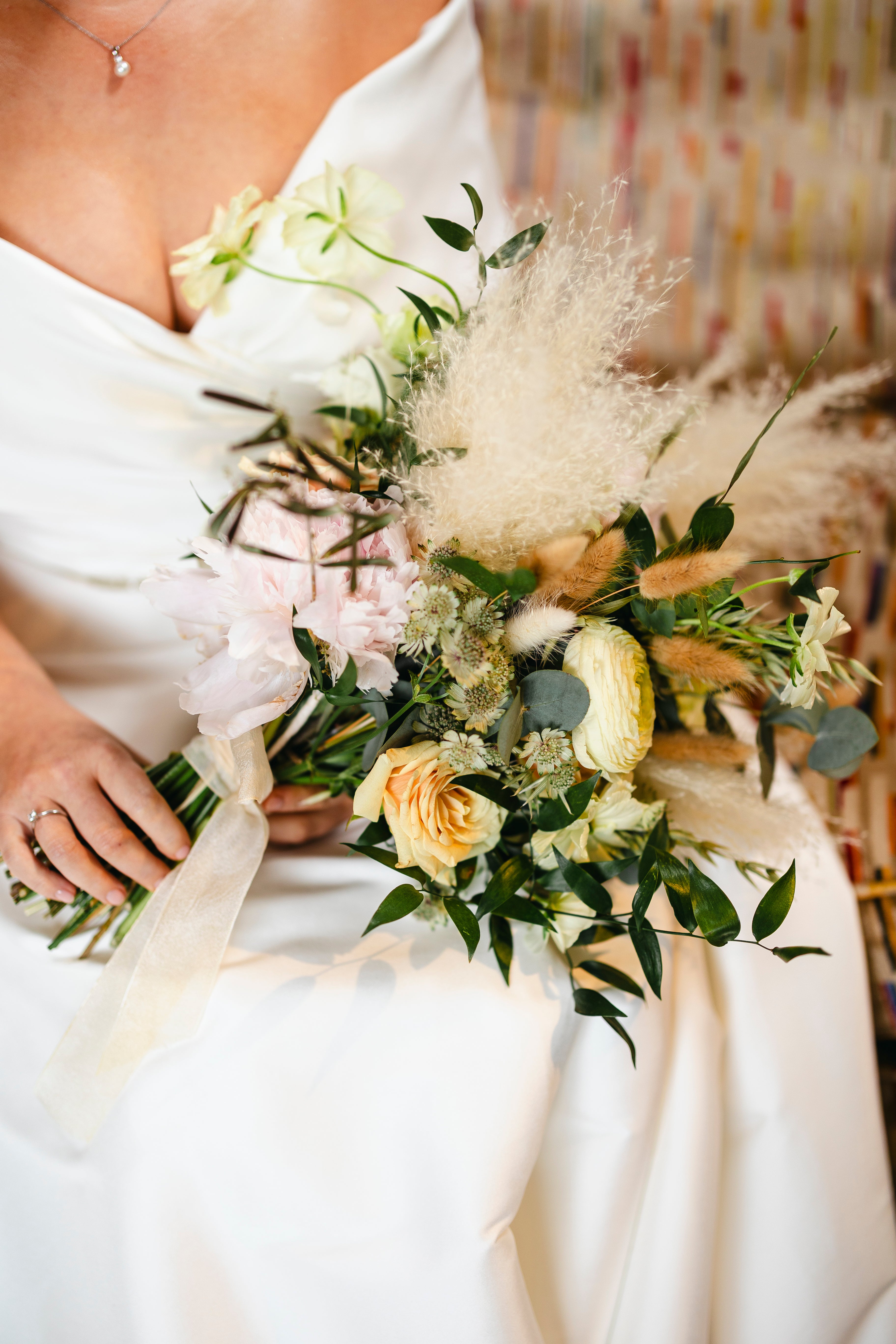 Bride holding a bouquet of flowers with a blurred background