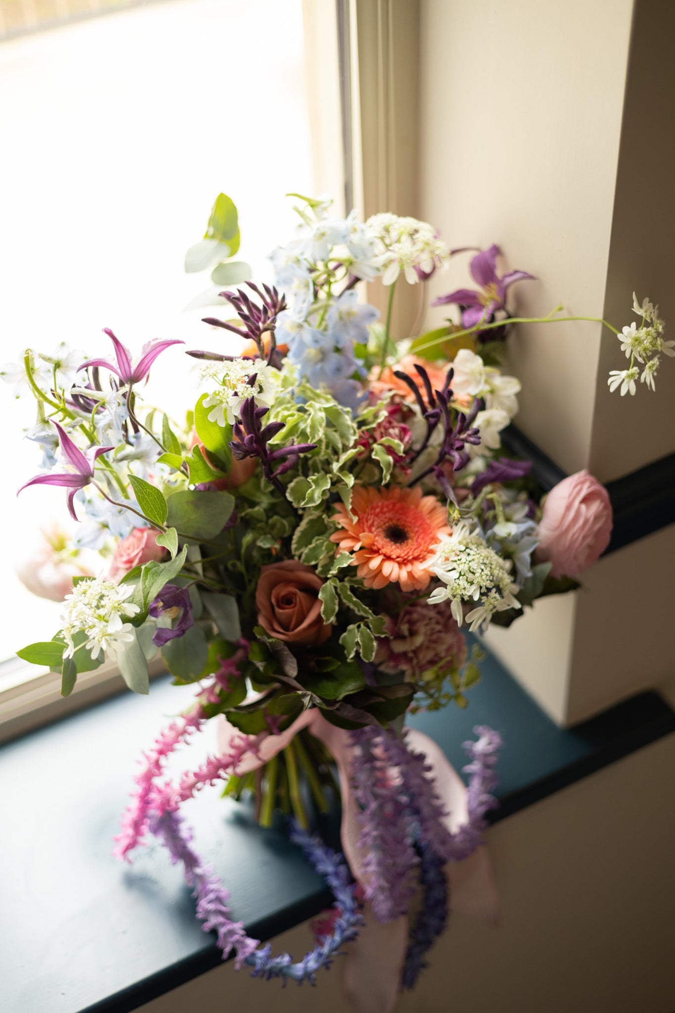Colorful bouquet of flowers on a windowsill with a blurred background